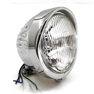 Faro estilo Springer con ranuras verticales y visera superior para moto custom